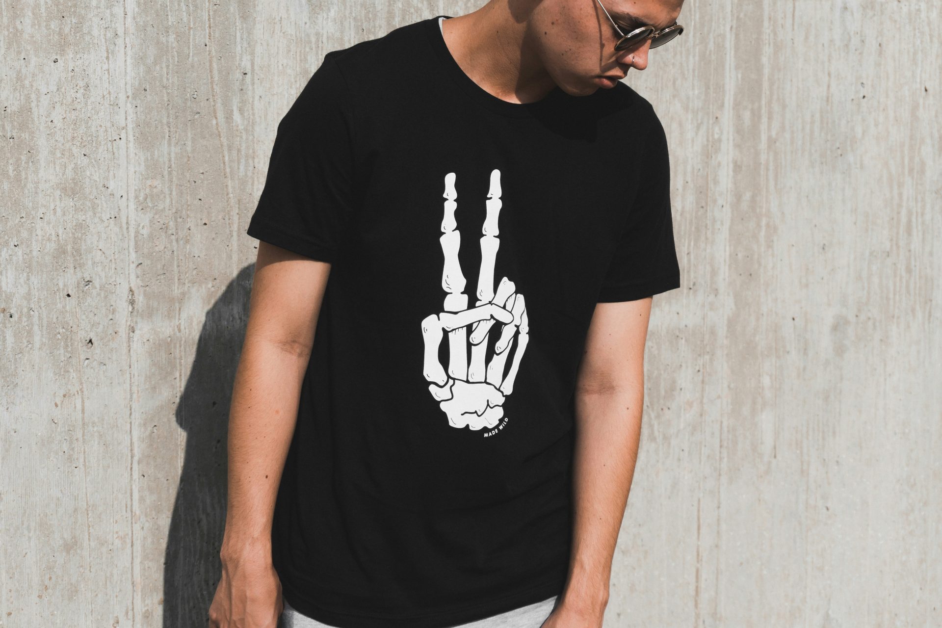 Man wearing a black t-shirt with a peace symbol